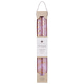 A set of tapered candles with a floral pattern, predominantly pink in color, packaged in a clear box with a white label.